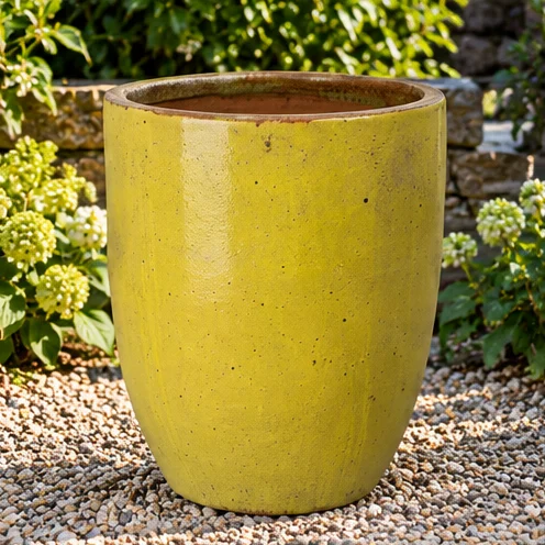 Rounded planter with a textured yellow glazed finish