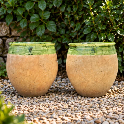 Pair of rounded earth-toned planters with green upper detailing
